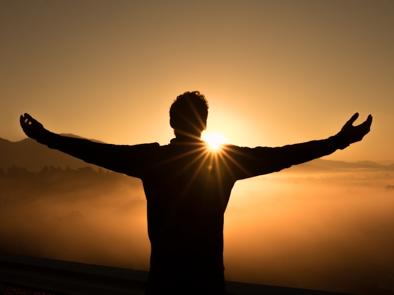 A person feeling calm and supported at sunrise